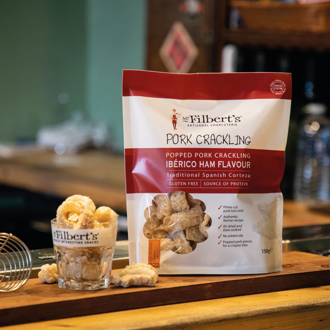 Mr Filbert's Ibérico ham flavour pork crackling bag on a bar counter
