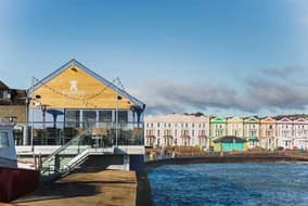 Waterfront restaurant on a harbour with colourful seafront houses