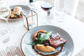 Restaurant dish of lamb with potato, red wine and candlelight