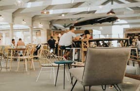 Spacious university café seating area with students