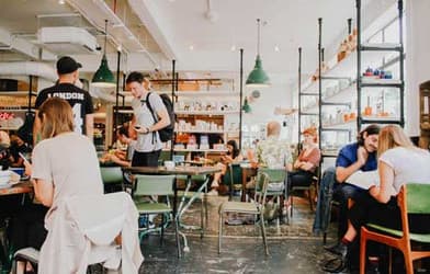 Busy campus café with students sitting at tables