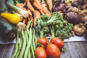 Fresh vegetables including carrots, beans, tomatoes and broccoli