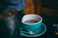 Cup of tea in a turquoise cup and saucer