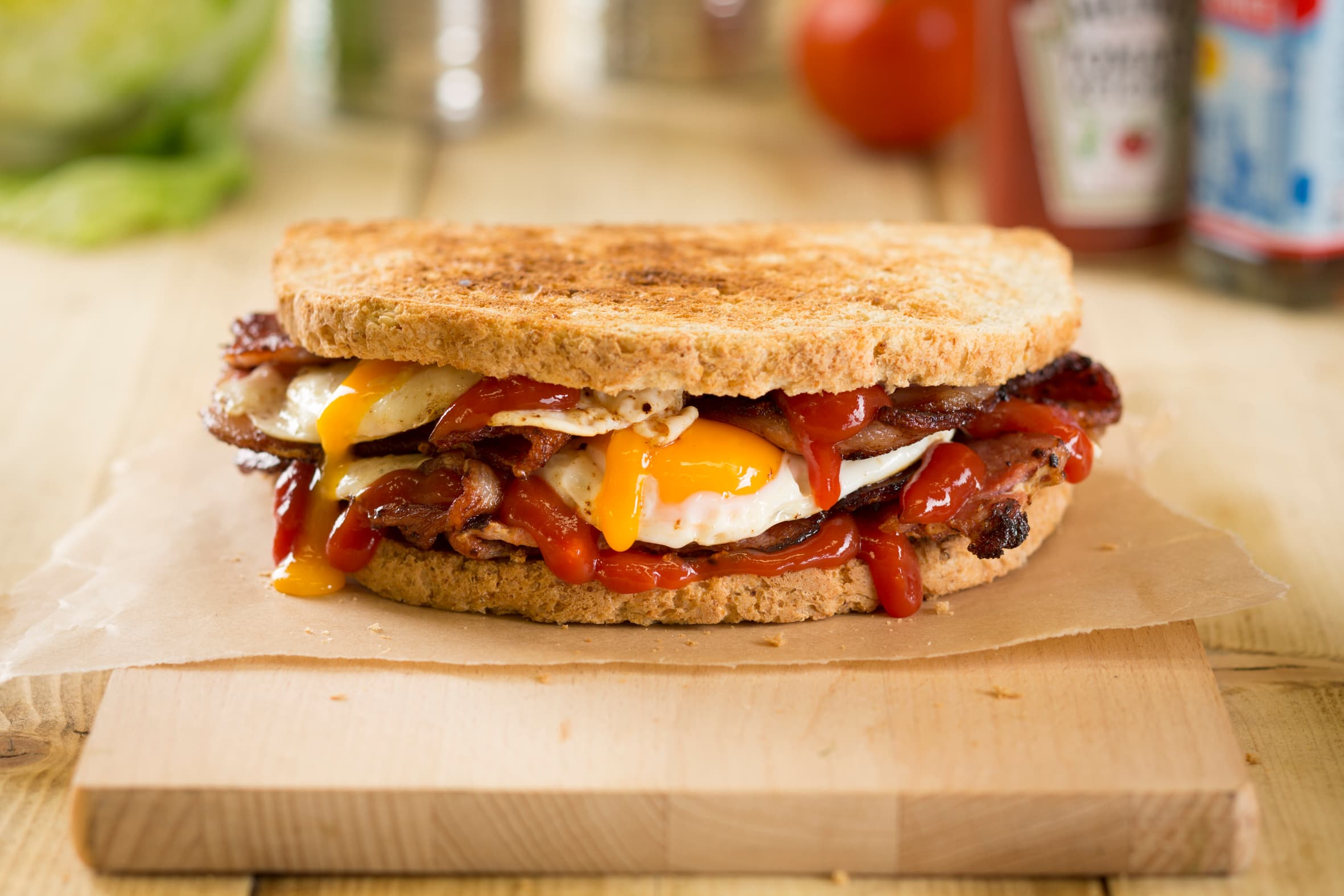 Toasted bacon and fried egg sandwich with ketchup