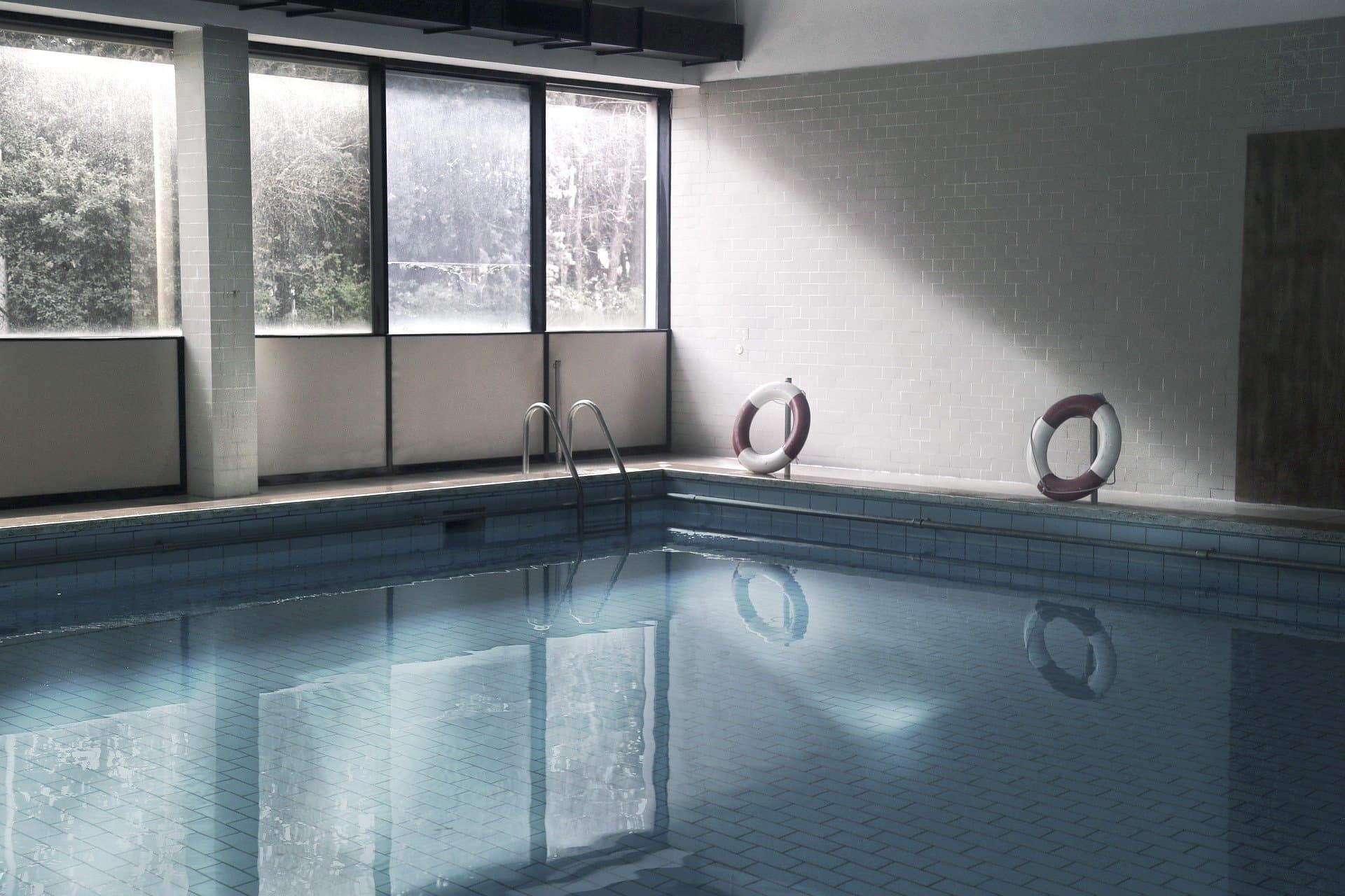 Hotel indoor swimming pool with lifebuoys on the wall