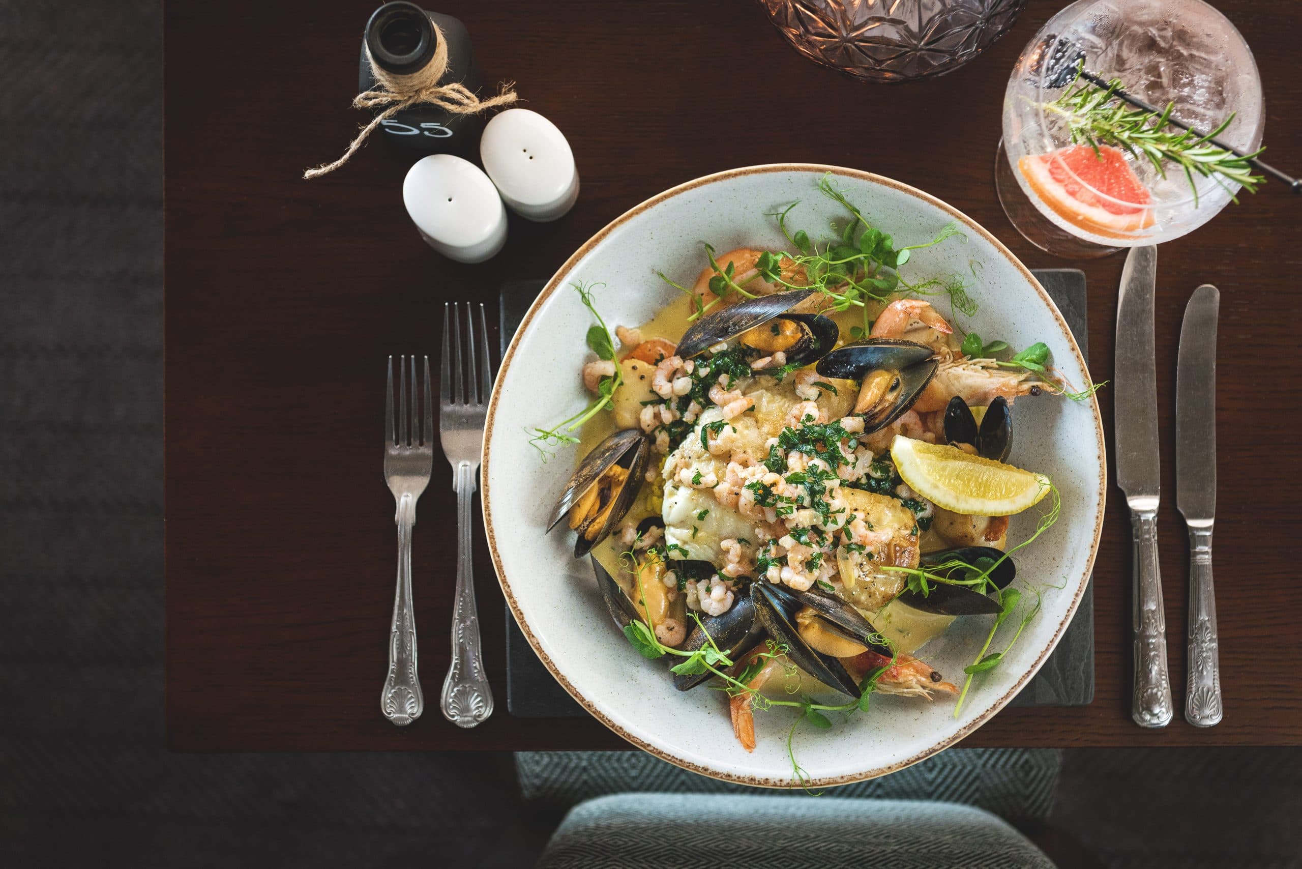 Seafood dish with mussels and prawns on a laid hotel restaurant table