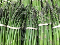 Bundles of fresh green asparagus spears tied with bands