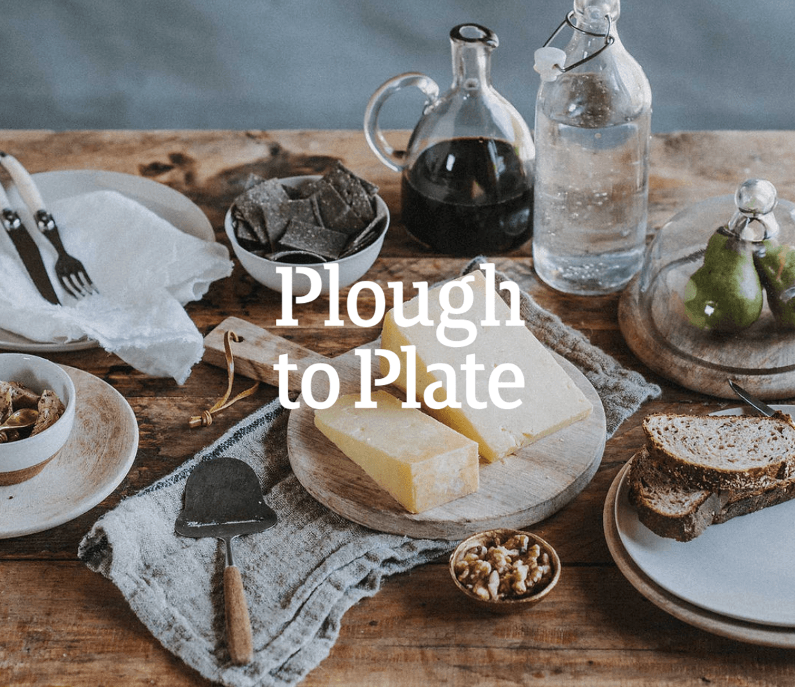 Plough to Plate title over a rustic spread of cheese, bread, crackers and pears