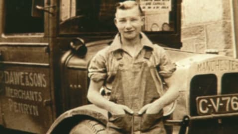 Vintage photo of a young man by a Dawe & Sons merchants of Penryn lorry