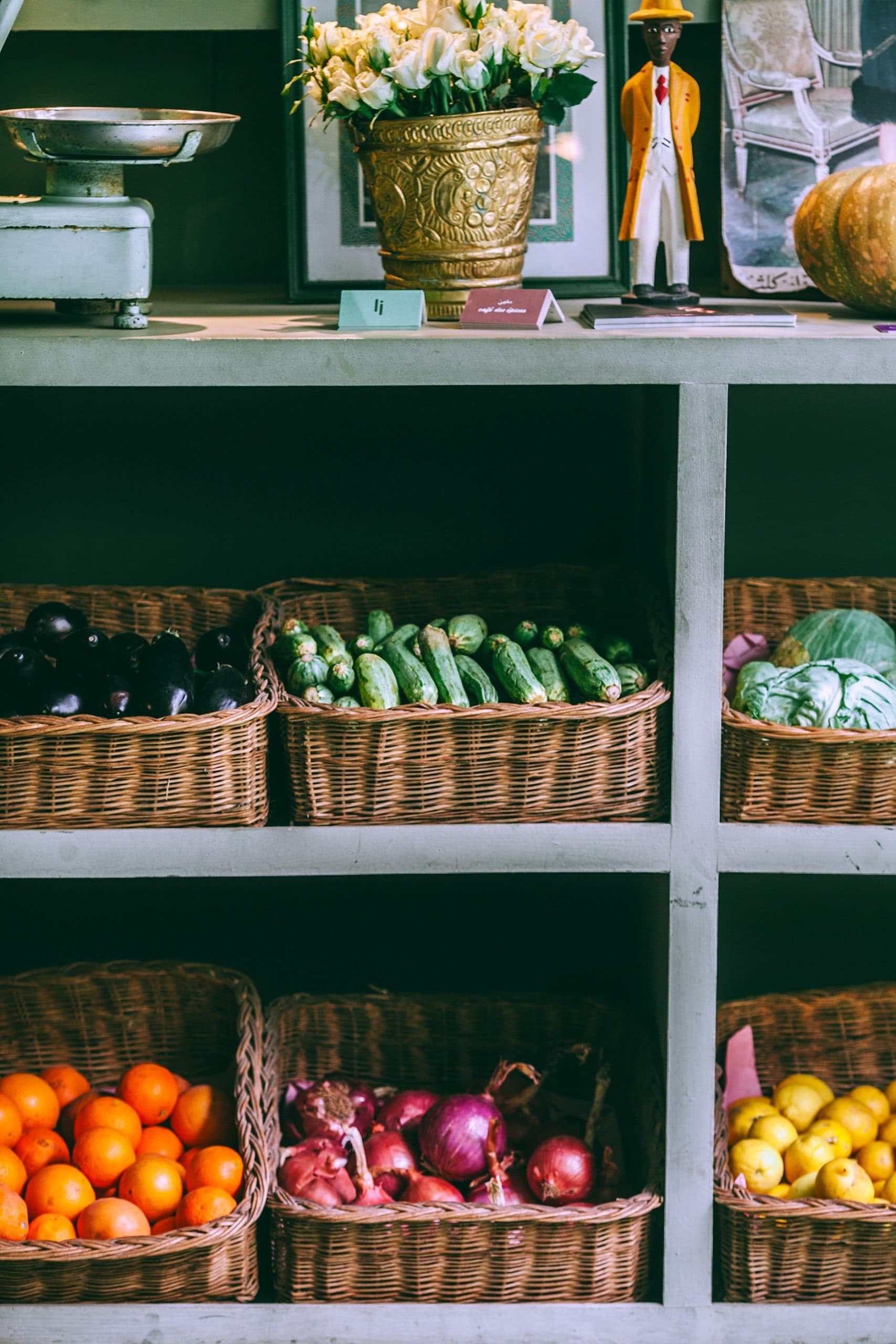 Farm shop shelves of vegetables and fruit in wicker baskets