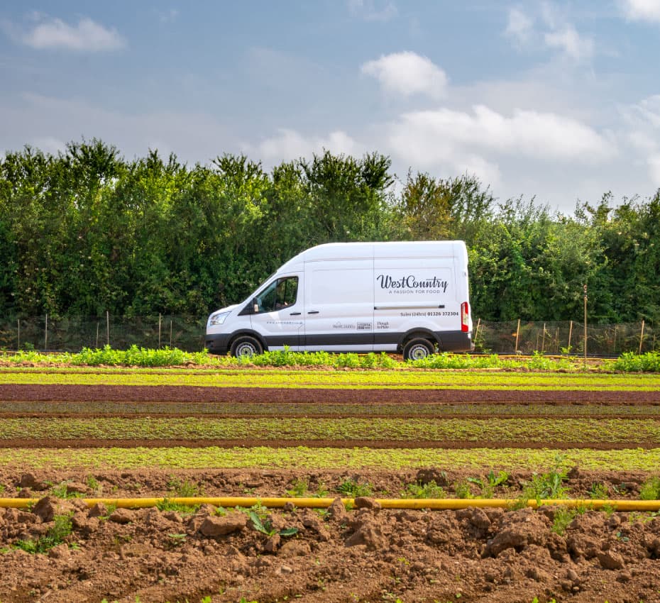 WestCountry Foodservice delivery van passing salad fields under a blue sky
