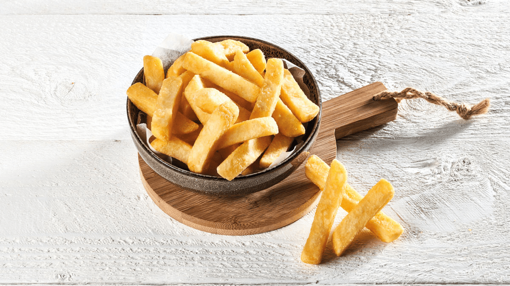 Bowl of chunky chips on a wooden board
